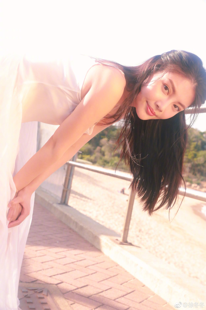 性感女星徐冬冬晒出一组海边写真白色吊带裙仍